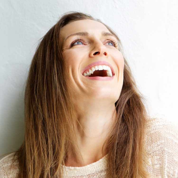 gum graft alternatives at norburn dental centre in burnaby woman smiling and looking up
